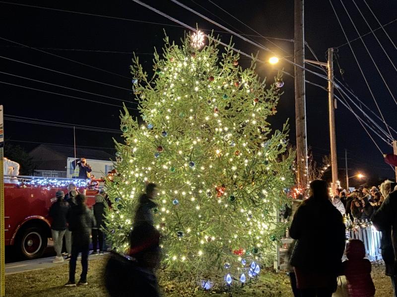 With the tree lit, children line up for a visit with Santa.